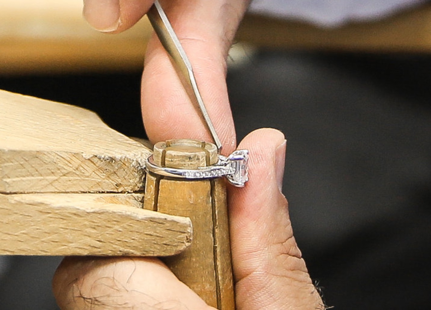 a jewelery craftsman selecting a diamond